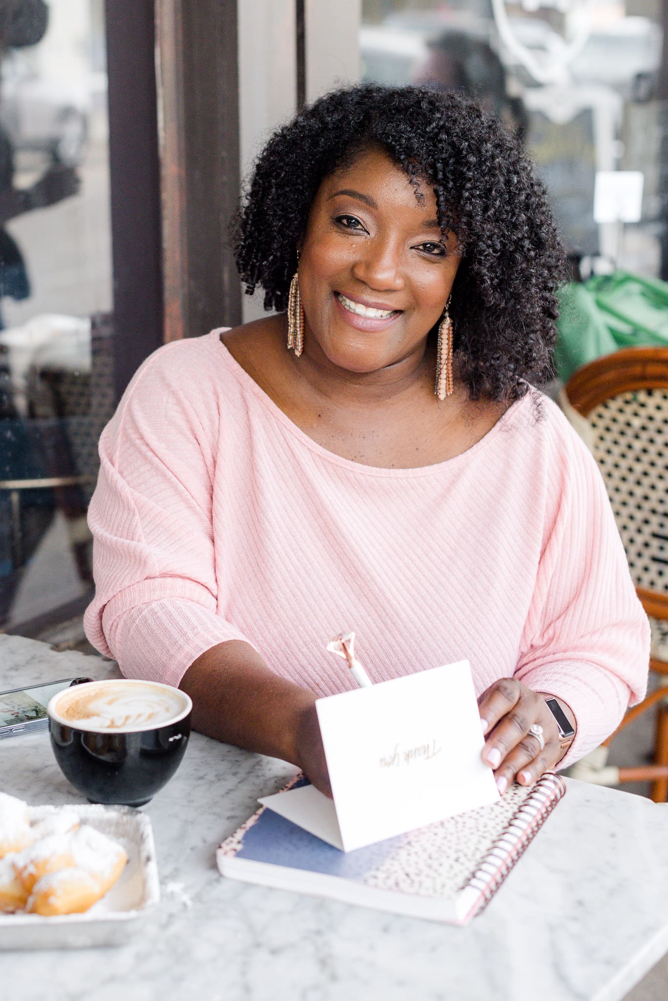Shenica Powe of Perfect Images Photography smiling while holding a thank-you card