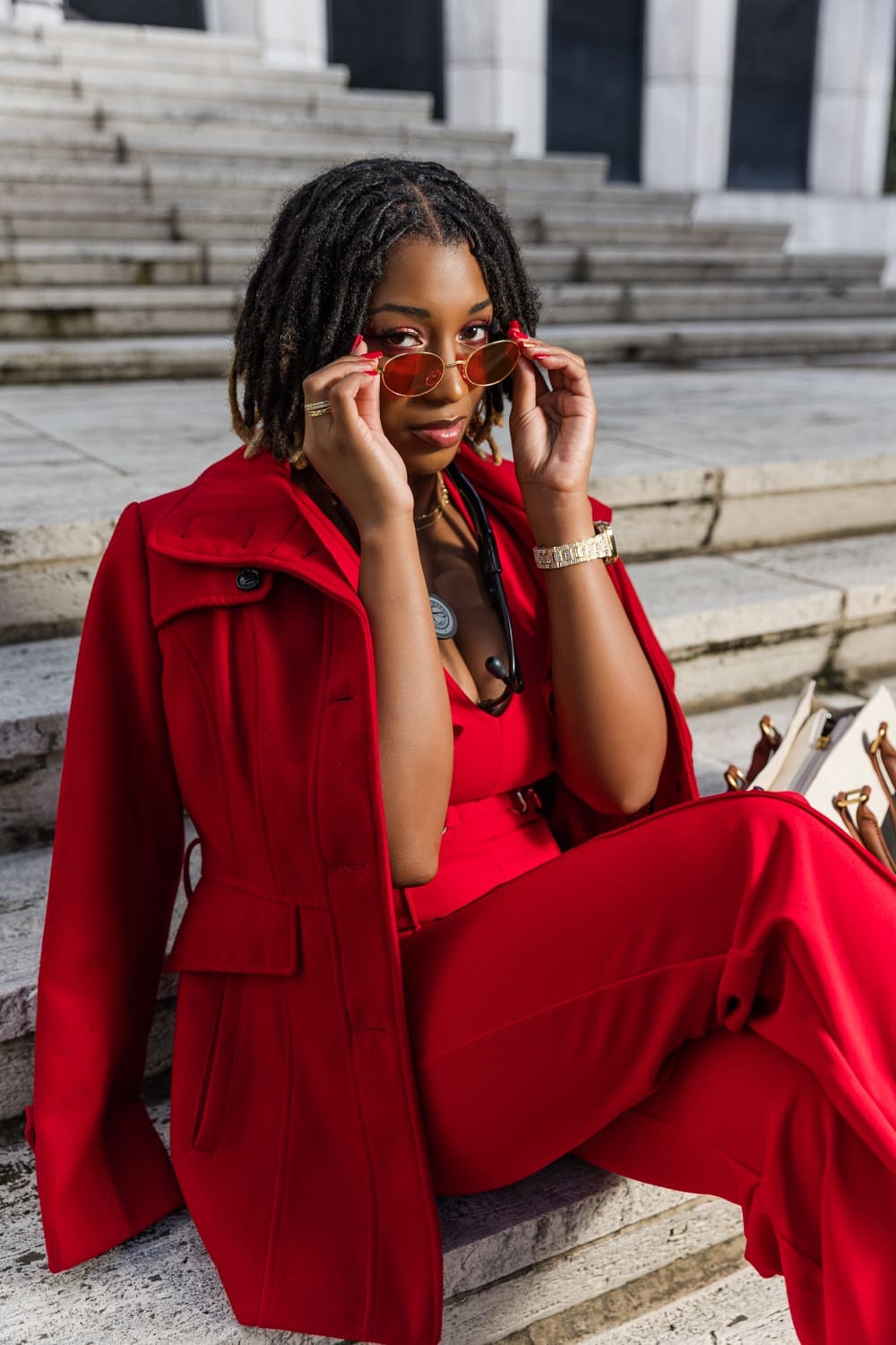 nurse wearing a red all in one jumpsuit with red sunglasses