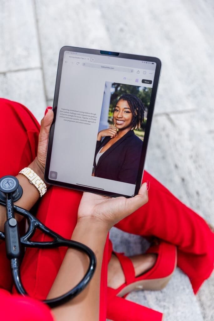 nurse holding ipad with her website pulled up showing her about me page with a picture of her displayed
