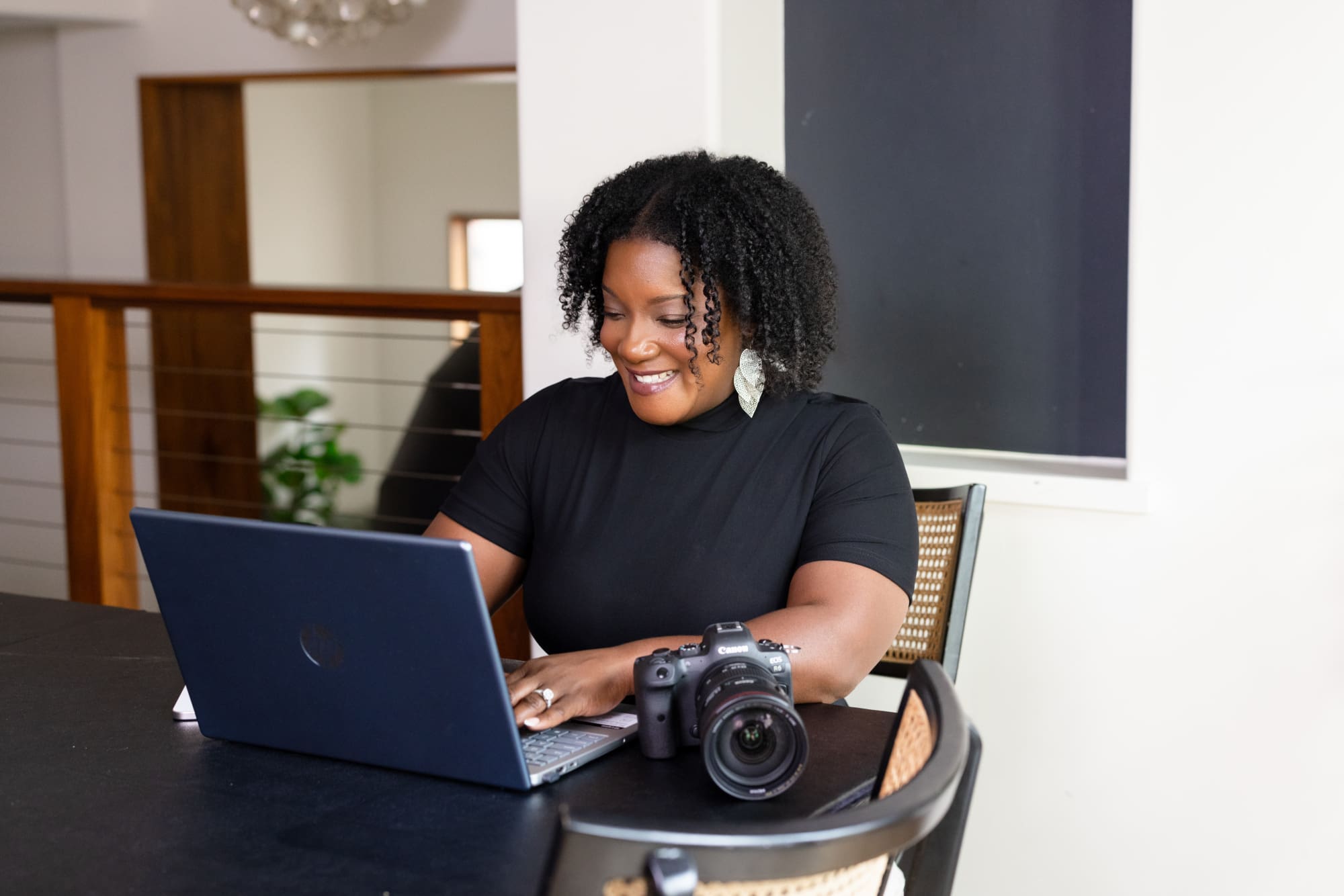 photographer sitting at the table working on her website