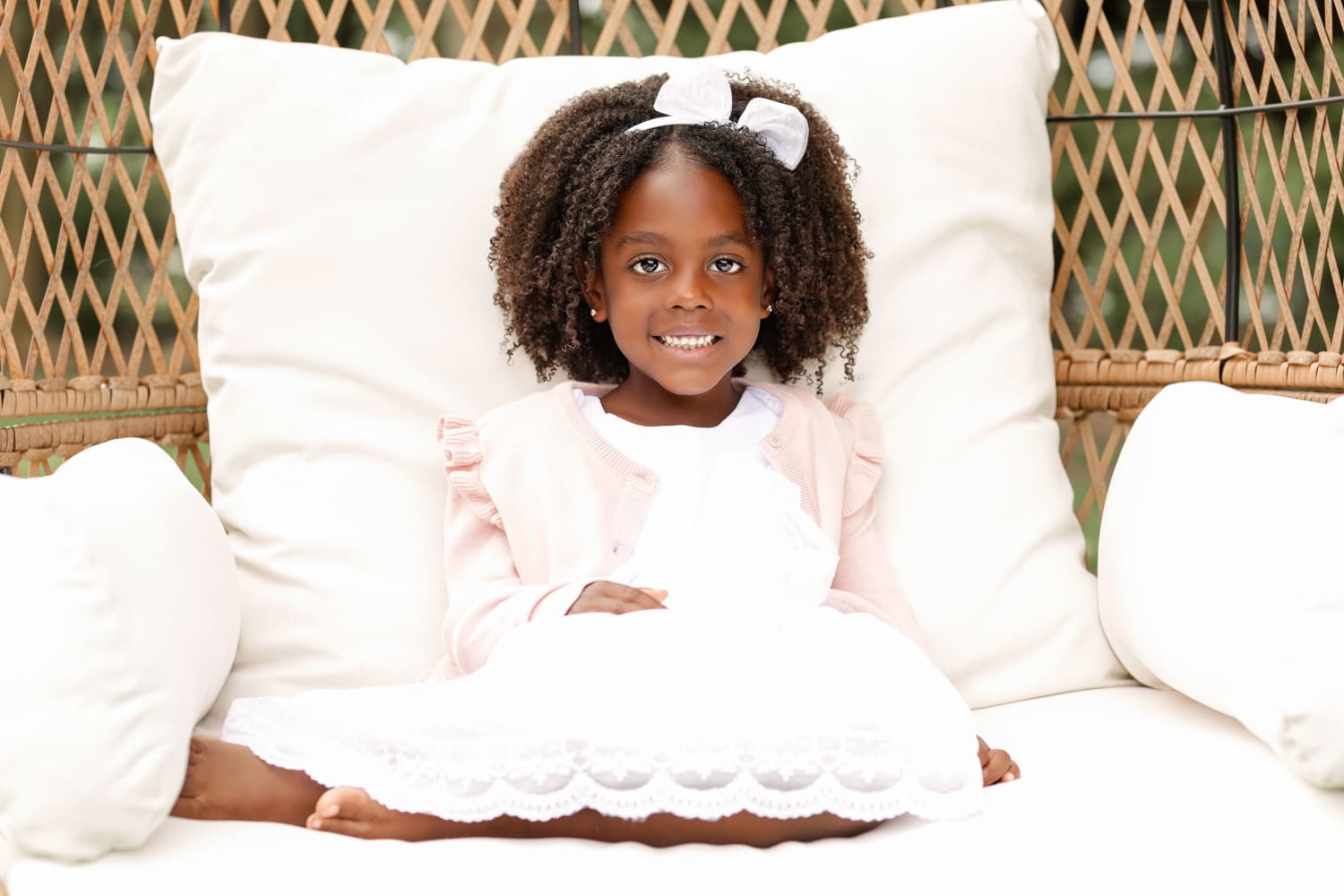 little girl wearing white dress with lace at the bottom
