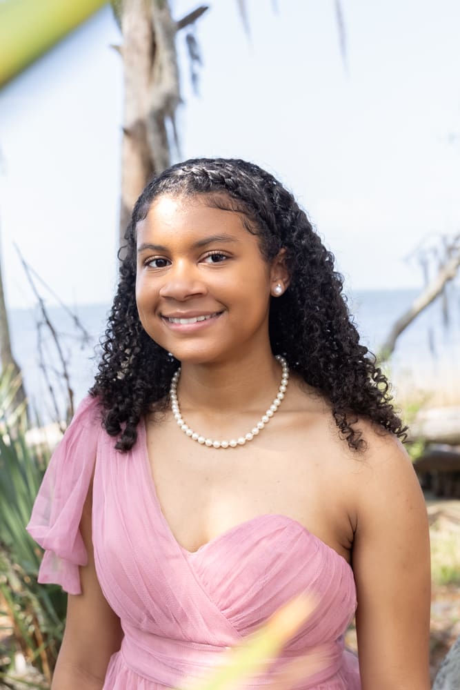 Teen girl celebrating golden birthday during outdoor photoshoot in Louisiana