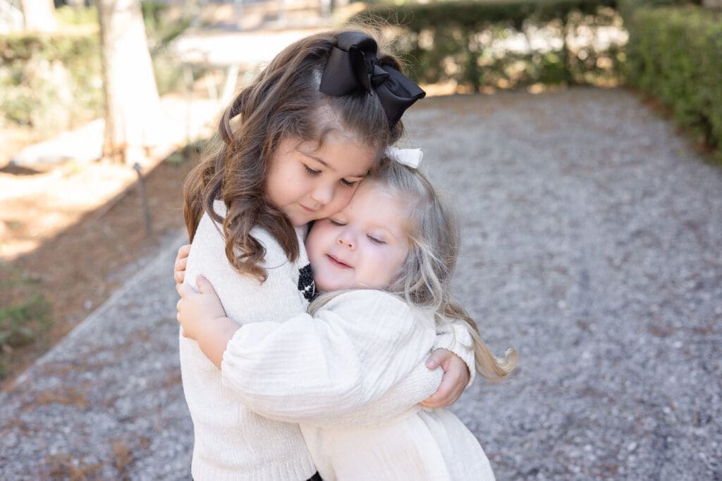 Lifestyle family photographer Zachary LA - sisters sharing a candid moment.