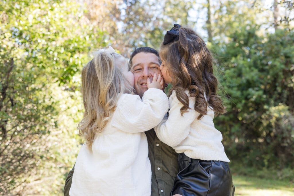 Candid family photography Zachary LA - parent and daughters connection shot.