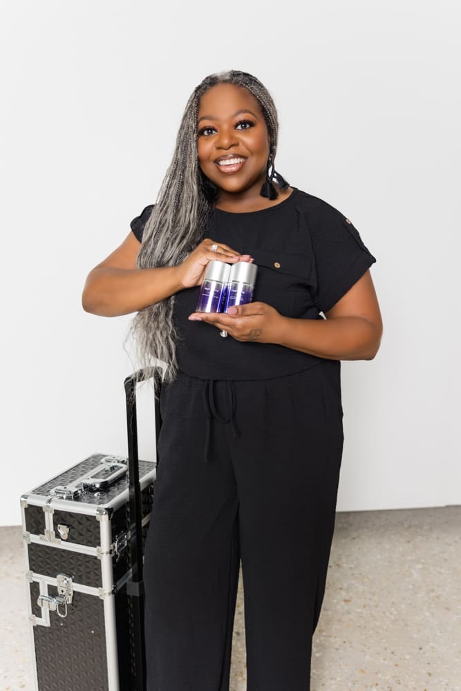 Licensed esthetician holding skincare products during a branding photography session.