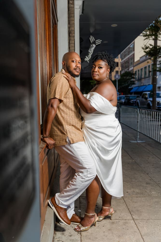 Downtown Baton Rouge engagement session with a couple sharing a romantic moment at sunset.