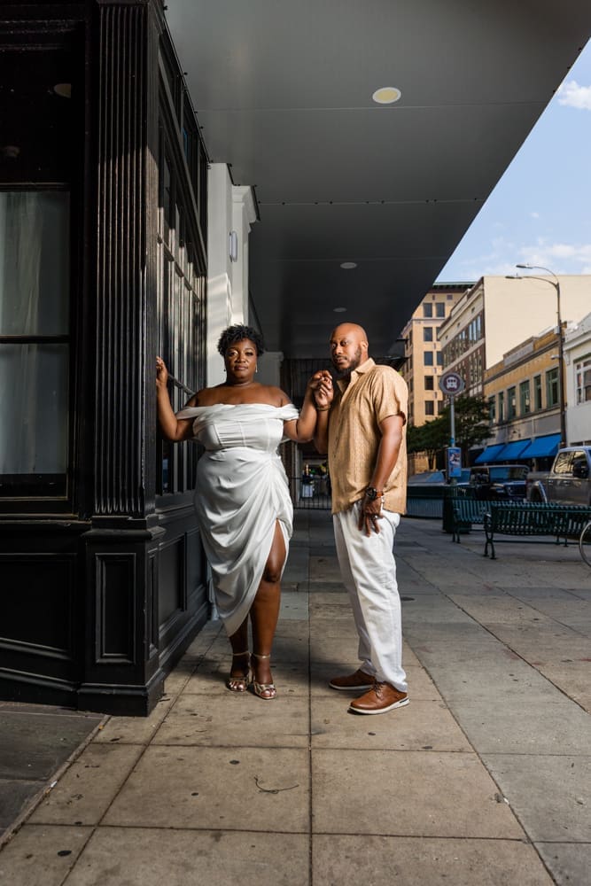 Couple smiling together during their engagement session in Downtown Baton Rouge.